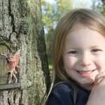 Fairy tale door with fairy in tree trunk