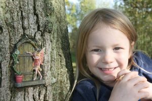 Fairy tale door with fairy in tree trunk