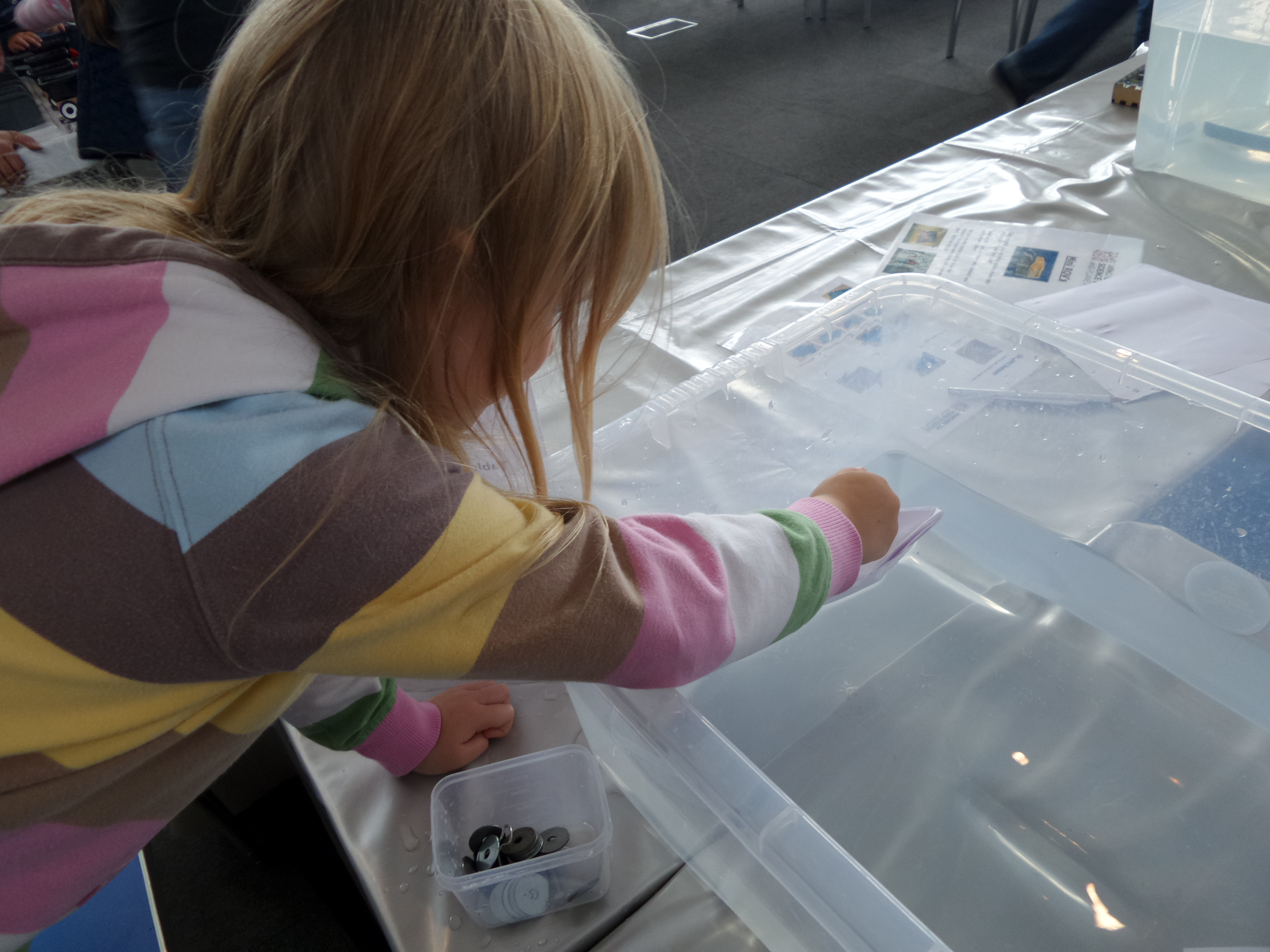 making a paper boat and putting it on the water