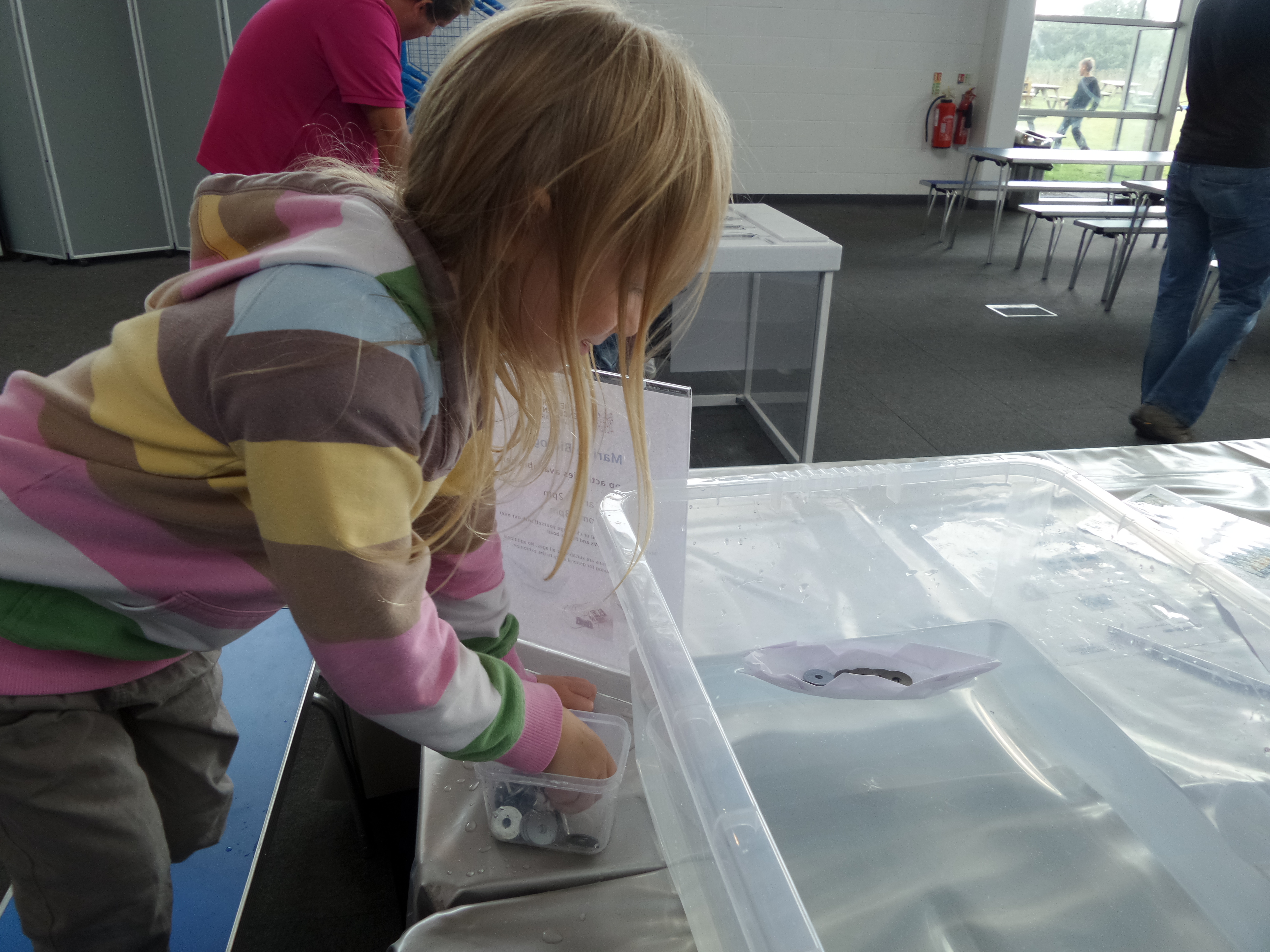 putting weights in the paper boat at winchester science centre