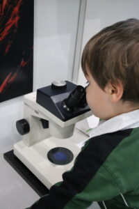 cody looking in microscope at oxfordshire museum