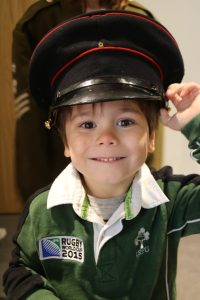 Boy wearing an army parade hat
