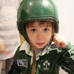 Cody wearing a green soldiers helmet