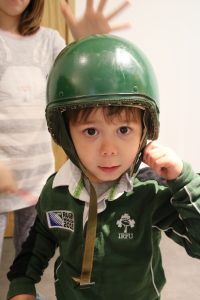 Cody wearing a green soldiers helmet