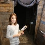 lilian holding her clipboard and looking at the trench