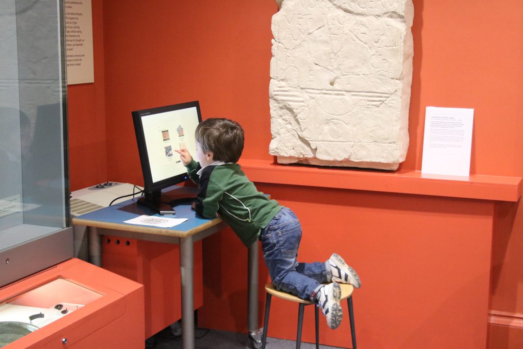 Cody using the interactive screen at The Oxfordshire Museum