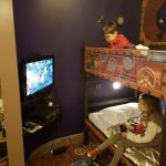 kids playing xbox in their hotel room
