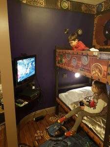 kids playing xbox in their hotel room