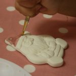 Cody painting his santa ornament