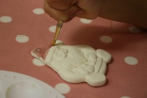 Cody painting his santa ornament