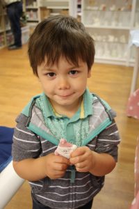 Boy holding his finished santa ornament