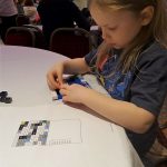 Girl building her lego mosaic