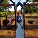 cody on slide in La Cabana play park