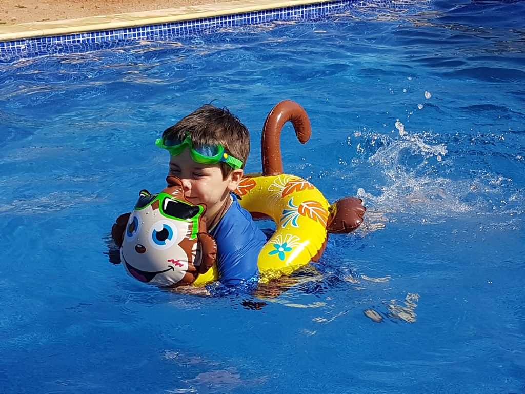 Cody swimming with an inflatable ring