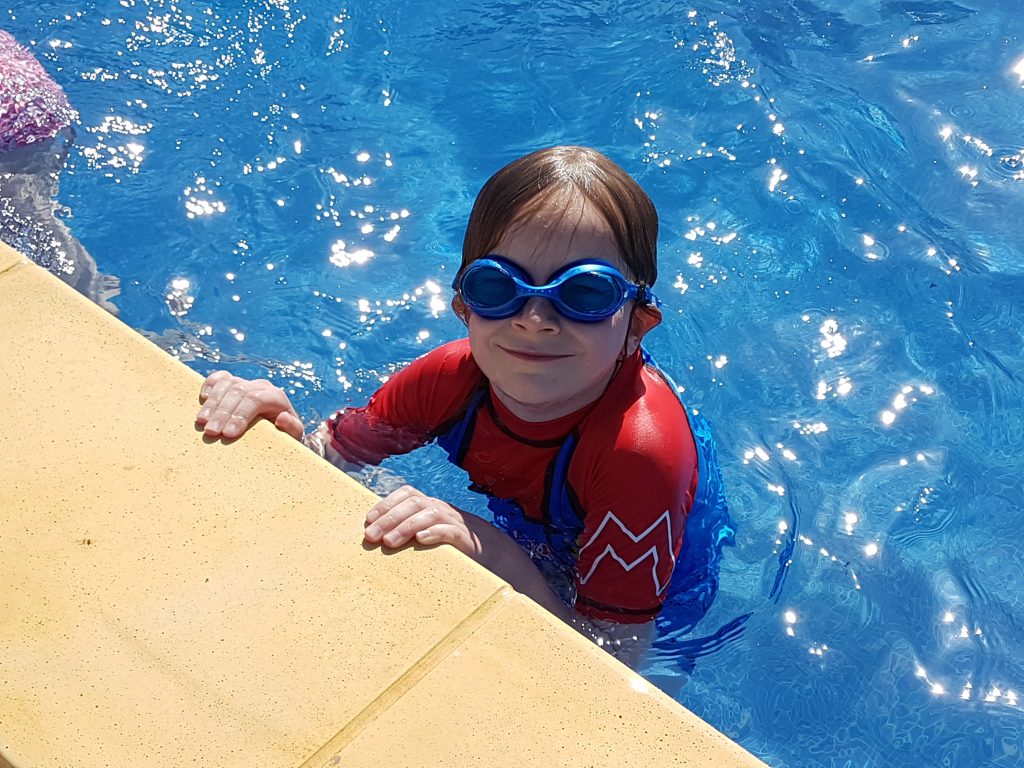 Lois in the pool wearing goggles