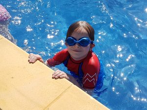 Lois in the pool wearing goggles