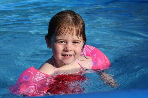 Lilian in the swimming pool wearing arm bands