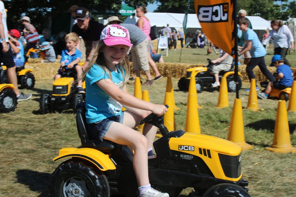 Lois riding a toy tractor at BBC Countryfile Live