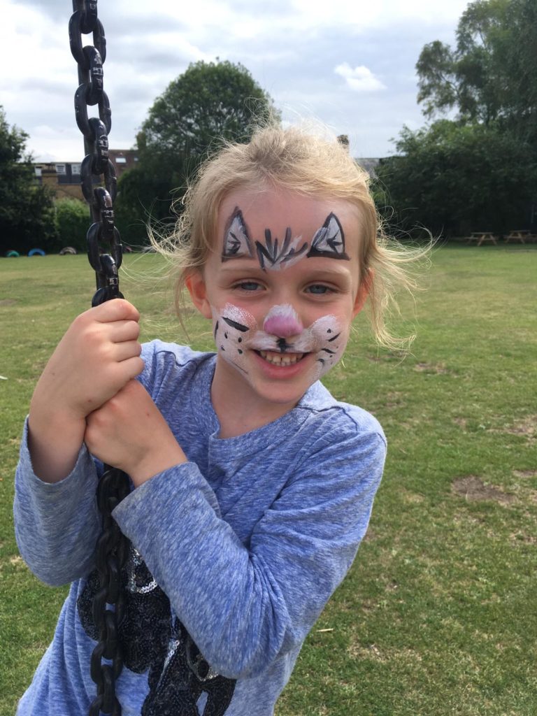 kid with face painted at house of fun