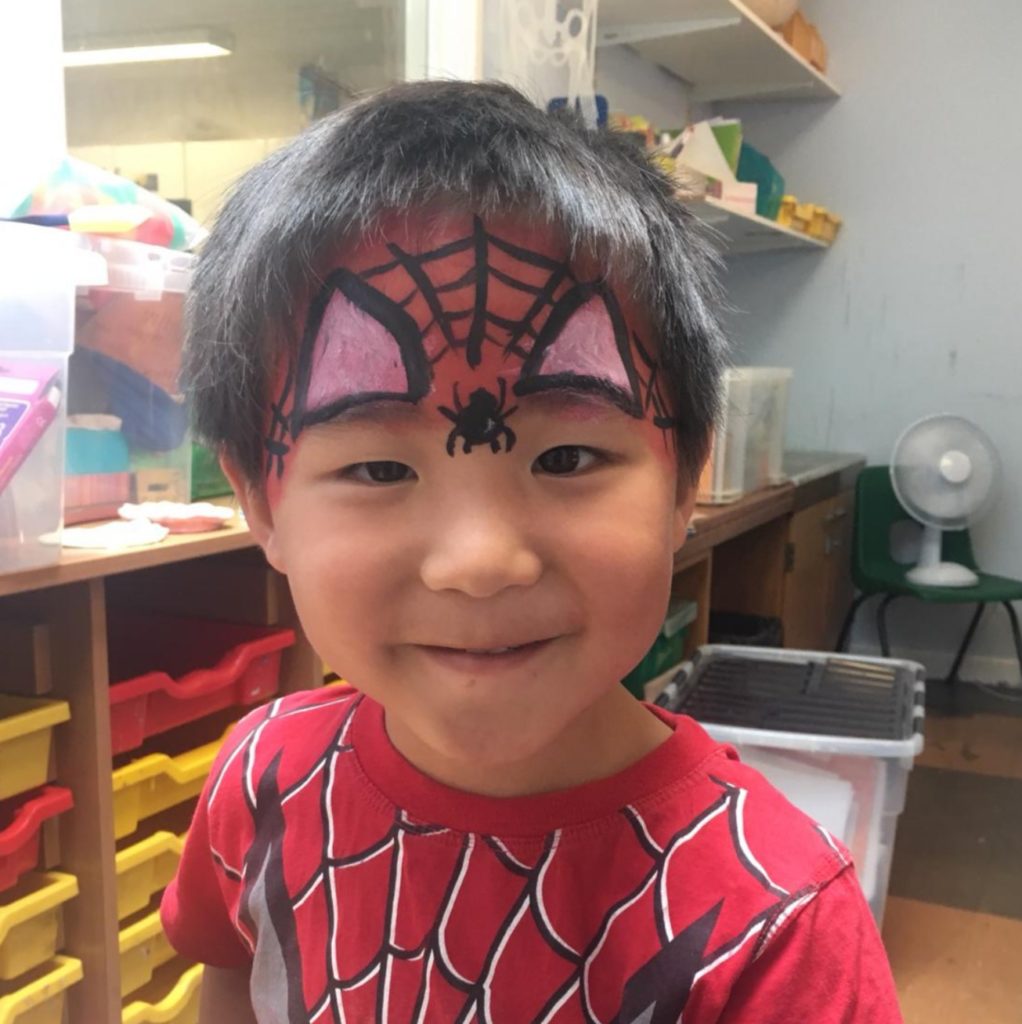 little boy with spiderman tshirt and face paint at house of fun