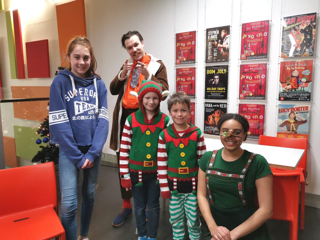 Children with the 5 cast members from Pinocchio at Cornerstone Arts Centre