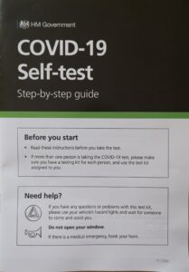 Front page of Covid-19 test guide white with black test