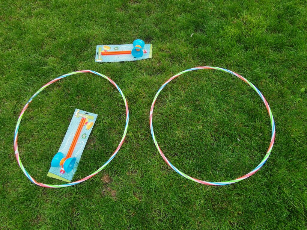 hula hoops and diablos laid on grass