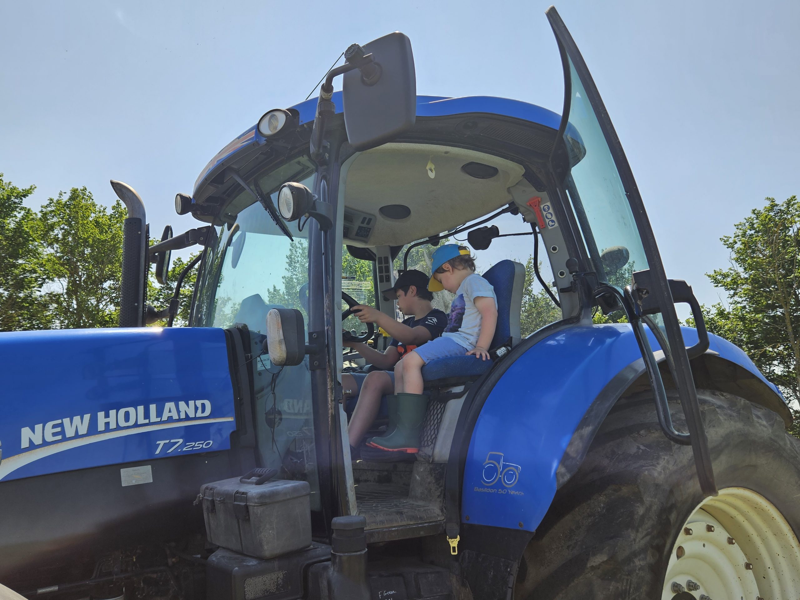 2 boys sat in tractor cab