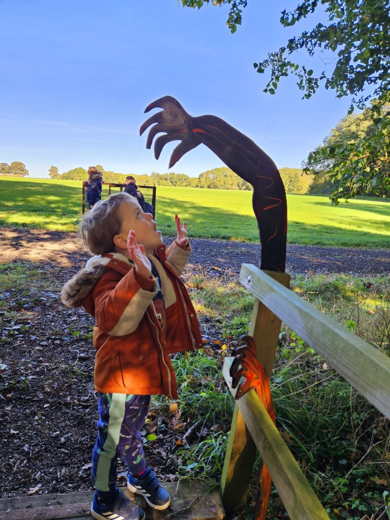 spooky hand coming over rail above child's head
