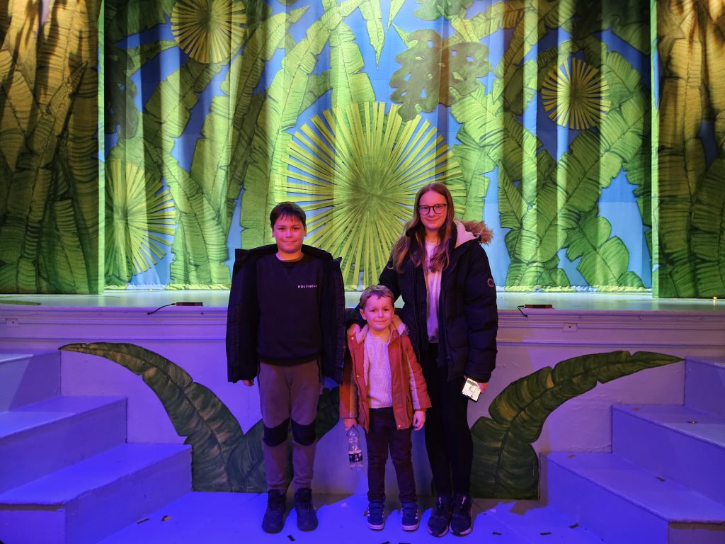 3 children stood in front of stage at The Theatre Chipping Norton