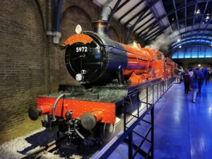 Red steam train at station platform