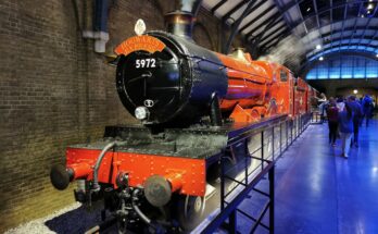 Red steam train at station platform