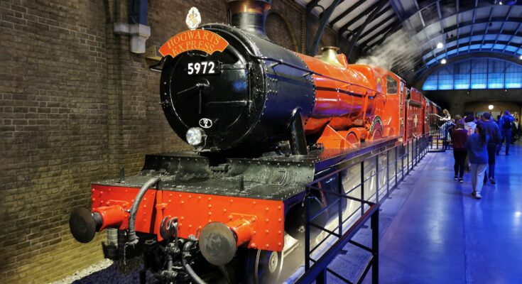 Red steam train at station platform