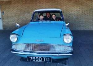 3 people in blue car at Harry Potter Warner Bros Studio Tour