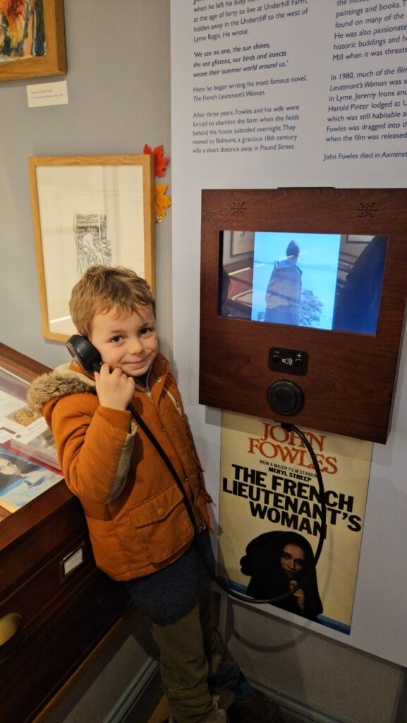 Young boy listening to telephone in museum