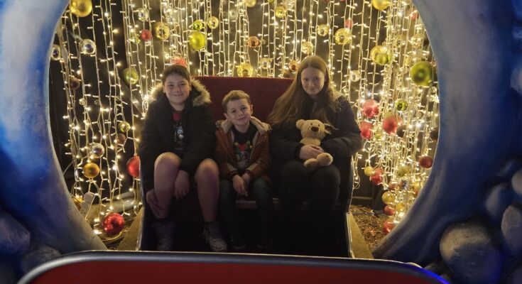 3 children sat on sleigh during Christmas at 4 Kingdoms Magical Adventure