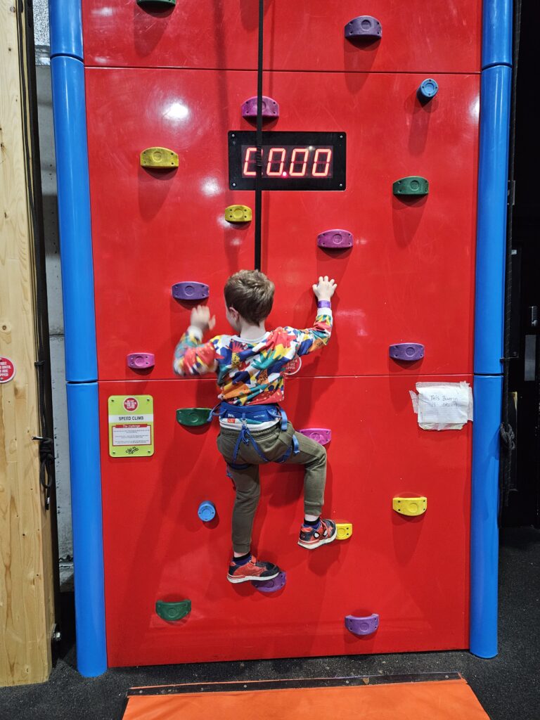 Red climbing wall with timer at Clip n Climb Reading